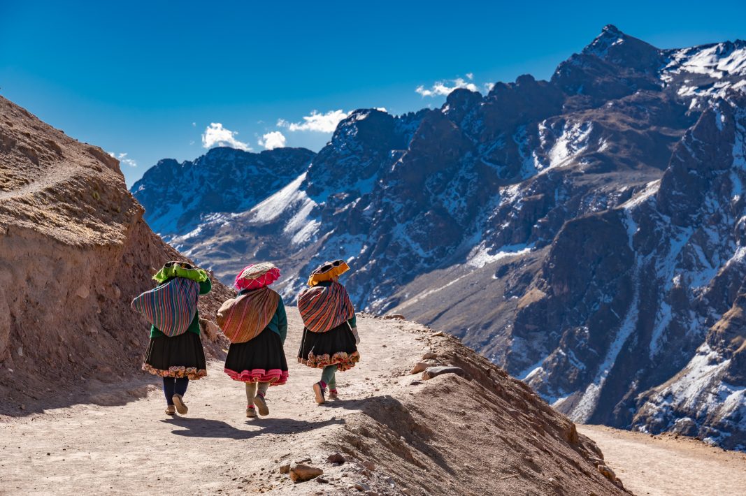 Peruvian vendors walking down from rainbow mountain.